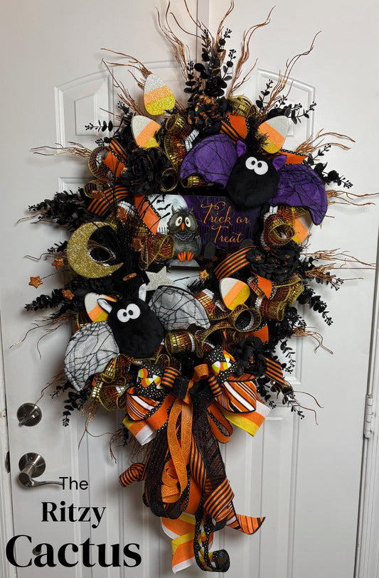 Oversized Halloween Wreath, Trick or Treat sign, Plush Bats, Candy Corn, Glitter Moon and an Oversized Bow